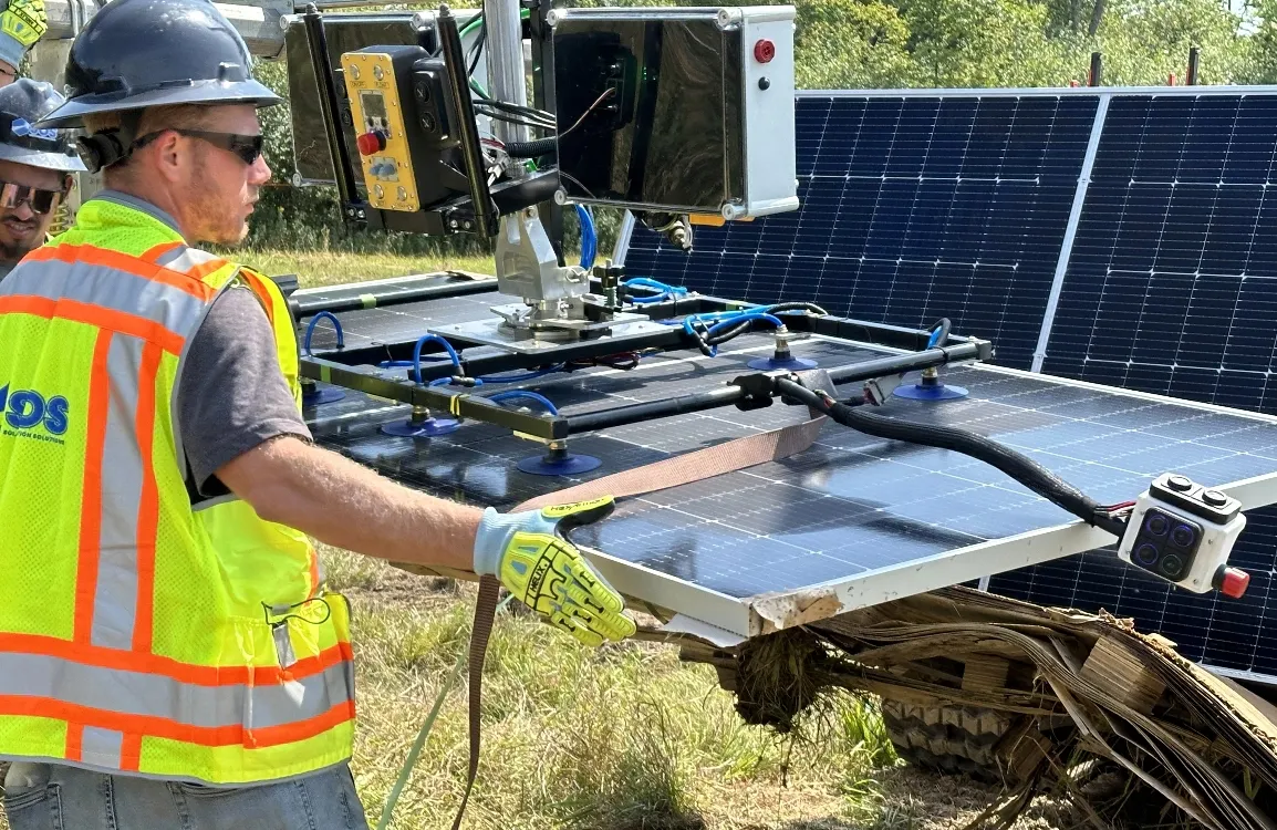 Worker moving solar panel with CrewMate